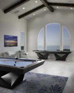 A modern home with high ceilings and multiple billiards tables