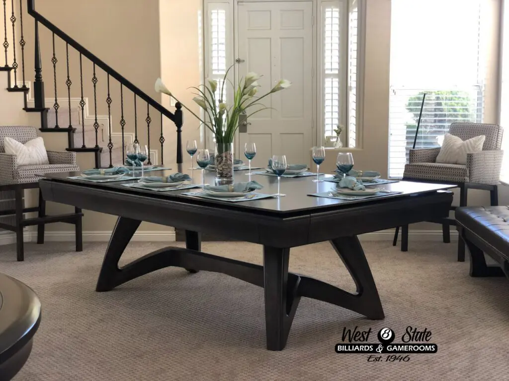 A wood table with a glass top with dining sets