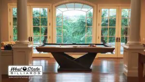 Origami pool table in home with big windows
