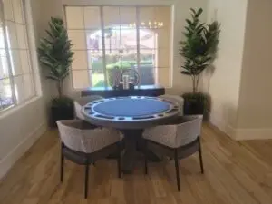 Four chairs below a california chic card table