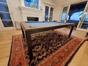 A pool table in a home on an elegant rug