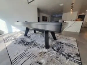 A sleek pool table on a tasteful rug